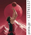 A basketball player in a powerful stance, holding a glowing basketball surrounded by flames, with a dramatic red moon in the background. Motivational concept for basketball enthusiasts. 127743157