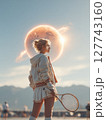 A female tennis player in her athletic outfit, focused on the red moon above as she prepares for a serve, with a clear blue sky and a tennis court in the background. Motivational concept for tennis 127743160