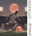 A football player in full athletic gear, poised to kick the ball with explosive power, under the bright stadium lights. Motivational concept for football lovers. 127743250
