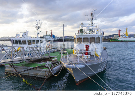 Kitakyushu, Japan - Dec 29,2022 : Cargo ship docking at Mojiko port in Kitakyushu, Japan on Dec 29,2022. Kitakyushu, Japan - Dec 29,2022 : Cargo ship docking at Mojiko port in Kitakyushu, Japan on Dec 29,2022. 127745370