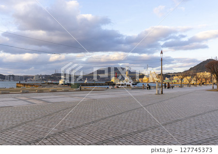 Kitakyushu, Japan - Dec 29,2022 : Cargo ship docking at Mojiko port in Kitakyushu, Japan on Dec 29,2022. Kitakyushu, Japan - Dec 29,2022 : Cargo ship docking at Mojiko port in Kitakyushu, Japan on Dec 29,2022. 127745373