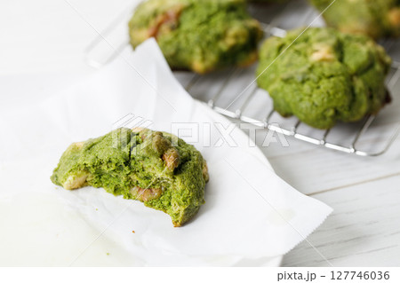 Closeup of fresh baked matcha cookies on white wooden background. 127746036