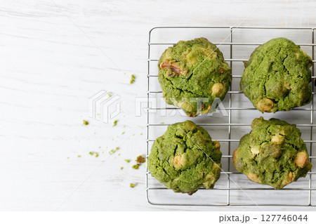 Closeup of fresh baked matcha cookies on white wooden background. Closeup of fresh baked matcha cookies on white wooden background. 127746044