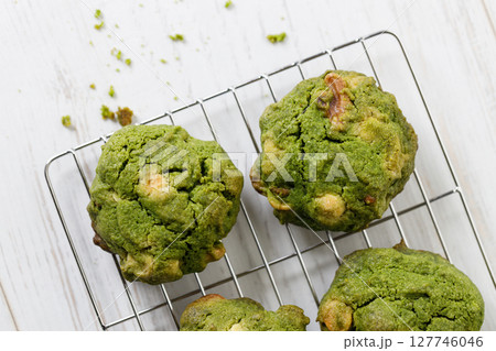 Closeup of fresh baked matcha cookies on white wooden background. Closeup of fresh baked matcha cookies on white wooden background. 127746046