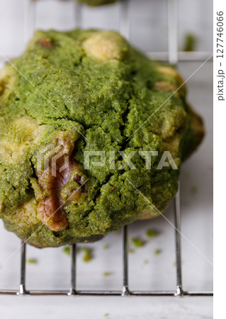 Closeup of fresh baked matcha cookies on white wooden background. Closeup of fresh baked matcha cookies on white wooden background. 127746066