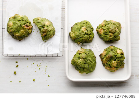 Closeup of fresh baked matcha cookies on white wooden background. 127746089