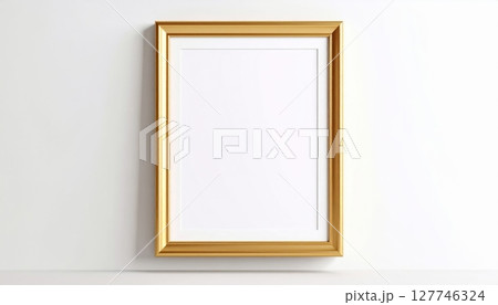 A blank, vintage wooden picture frame hangs on the wall, ready for a new photo or art 127746324