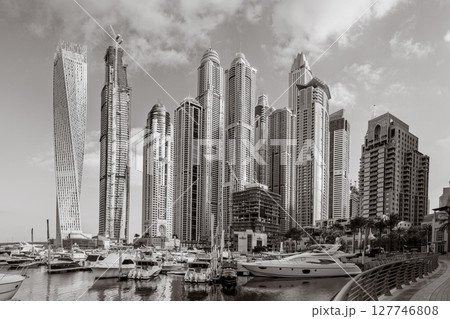 Panoramic view of Dubai Marina bay with yacht and cloudy sky, Dubai, UAE 127746808
