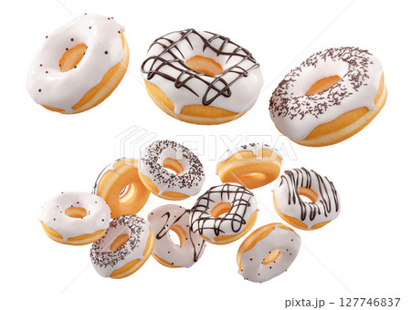Donuts with white chocolate glaze, sprinkles, white drizzle, and dots isolated on white transparent background 127746837