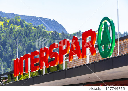Interspar supermarket brand logo red green welcome sign in Austria. Interspar supermarket brand logo red green welcome sign in Austria. 127746856