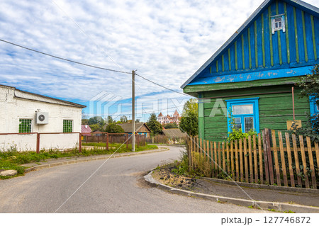 Mir Belarus Colorful Village Streets with Wooden Huts Cabins Houses. Mir Belarus Colorful Village Streets with Wooden Huts Cabins Houses. 127746872