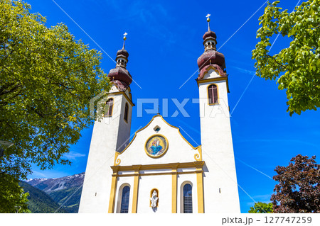 Barbara church cathedral Barbarakirche Fliess with blue sky Tyrol Austria. Barbara church cathedral Barbarakirche Fliess with blue sky Tyrol Austria. 127747259