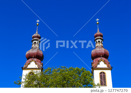 Barbara church cathedral with dome tower blue sky Tyrol Austria. 127747270