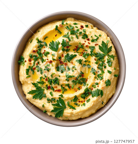 Fresh and Creamy Hummus Dip with Olive Oil and Herbs Served in a Decorative Bowl 127747957
