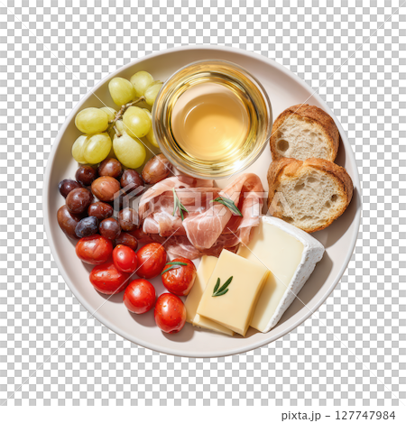 Delicious Mediterranean Platter with Cheese, Olives, Grapes, Tomatoes, Prosciutto and a Glass of White Wine 127747984