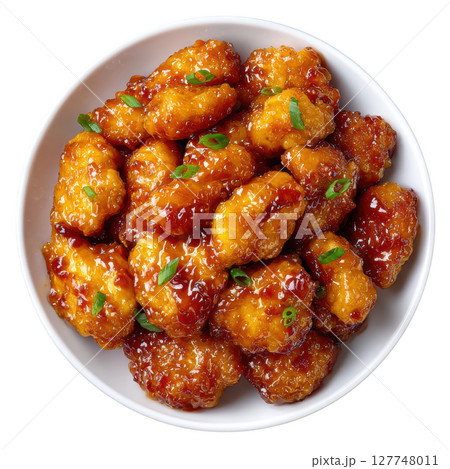 Delicious Orange Chicken Dish with Tender Bites and Glossy Sauce Garnished with Green Onions 127748011