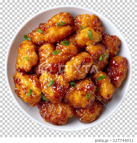 Delicious Orange Chicken Dish with Tender Bites and Glossy Sauce Garnished with Green Onions 127748011