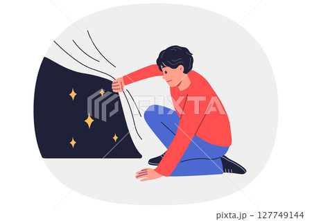 Man looks at starry sky hidden under fabric, experiencing curiosity at sight of unknown starry space 127749144