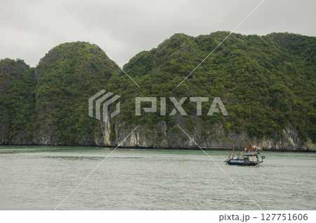 Limestone cliffs and fishing boat. Limestone cliffs and fishing boat. 127751606