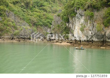 Fisherman in his boat rowing. Fisherman in his boat rowing. 127751859