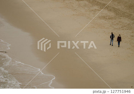 Couple walking on the beach. Couple walking on the beach. 127751946