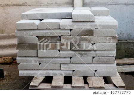 A pallet loaded with paver and stone material for outside construction. Represents key supply for landscaping and building projects A pallet loaded with paver and stone material for outside construction. Represents key supply for landscaping and building projects 127752770