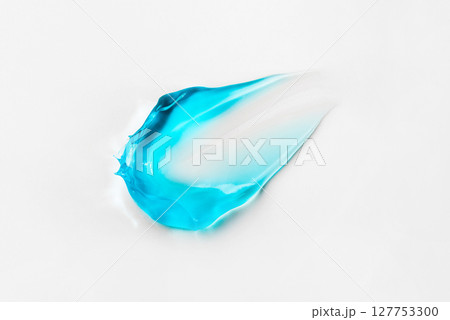 A smear of blue cosmetic hair gel on a white background A smear of blue cosmetic hair gel on a white background 127753300