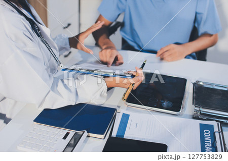 Young brunette woman having consultation at doctor office during Young brunette woman having consultation at doctor office during 127753829