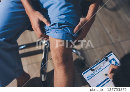 Physical therapist teaching a patient how to do exercises for his knee pain Physical therapist teaching a patient how to do exercises for his knee pain 127753873