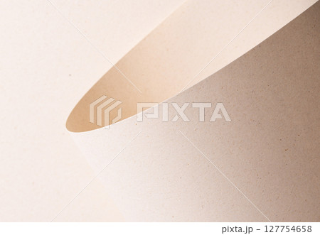 Curved sheet of elegant designer paper in creamy beige tones with tactile porous texture and organic 127754658