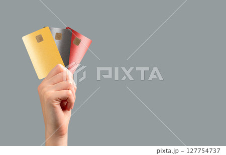 holding a bank card for secure payment at a retail store. Multiple options for transaction, 127754737