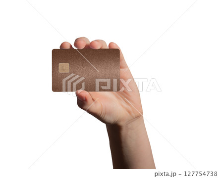 holding a brown bank card for payment, emphasizing security and financial services in a retail store 127754738