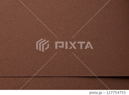 Luxury background with overlapping sheets of designer paper in rich chocolate brown tones. Pitted 127754755