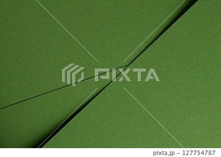 Premium paper surface close up. Green matte texture with smooth fiber detail, geometric overlap of Premium paper surface close up. Green matte texture with smooth fiber detail, geometric overlap of 127754787