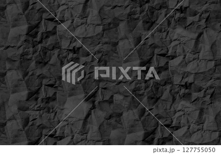 Crumpled black paper texture with rough, wrinkled surface and natural creases. Vintage, aged effect Crumpled black paper texture with rough, wrinkled surface and natural creases. Vintage, aged effect 127755050