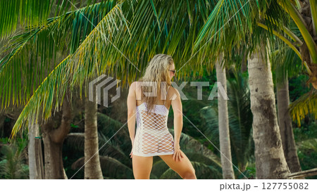 The tanned woman dances cool and appetizing on the beach of Koh Chang island in Thailand. Booty dancing twerk. Concept travel, walks, rest in sea, tropical resort traveling tourism summer holidays 127755082
