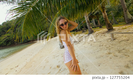 The tanned woman dances cool and appetizing on the beach of Koh Chang island in Thailand. Booty dancing twerk. Concept travel, walks, rest in sea, tropical resort traveling tourism summer holidays The tanned woman dances cool and appetizing on the beach of Koh Chang island in Thailand. Booty dancing twerk. Concept travel, walks, rest in sea, tropical resort traveling tourism summer holidays 127755204