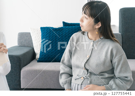 出産準備をしながら明るい未来の話をする母と娘 出産準備をしながら明るい未来の話をする母と娘 127755441