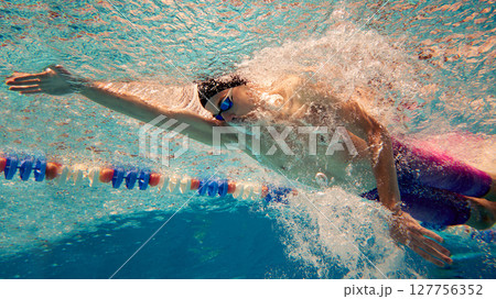 Underwater view of swimmer performing front crawl in pool Underwater view of swimmer performing front crawl in pool 127756352