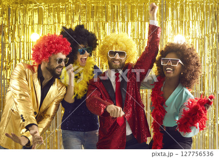 Happy multiethnic friends have fun dancing and laughing at a bright party. 127756536