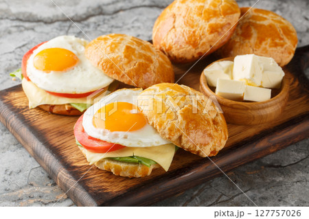 Hong Kong Style Fried Eggs Sandwich with tomato, cheese, lettuce close-up on wooden board. Horizontal 127757026