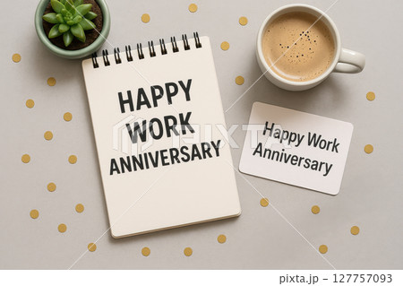 Happy work anniversary message written on notebook and card with coffee cup and green succulent plant on table creating happy work celebration atmosphere Happy work anniversary message written on notebook and card with coffee cup and green succulent plant on table creating happy work celebration atmosphere 127757093