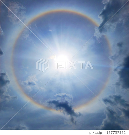 Halo. Rainbow circle around the sun 127757332