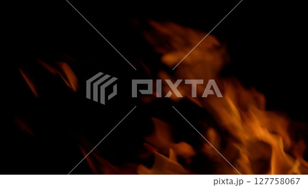 Dynamic Flames Against a Dark Background, Evoking Intense and Vibrant Imagery of Heat and Fire Dynamic Flames Against a Dark Background, Evoking Intense and Vibrant Imagery of Heat and Fire 127758067