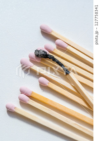 Group of pink matches and one burned match, burnout abstract concept Group of pink matches and one burned match, burnout abstract concept 127758341