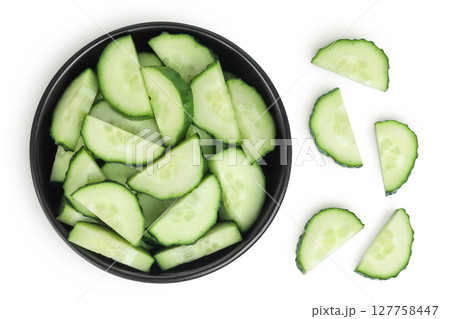 Sliced cucumber in ceramic bowl isolated on white background with full depth of field. Top view. Flat lay. Sliced cucumber in ceramic bowl isolated on white background with full depth of field. Top view. Flat lay. 127758447