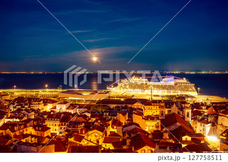 View Of Lisbon Skyline Old Historical City In Portugal, Alfama at night with port and ferry ship 127758511