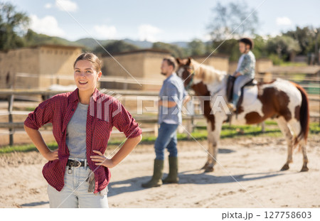 Young woman posing in horse pen 127758603