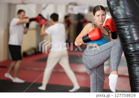 Woman kicking a pear tree 127758619