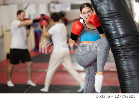 Woman kicking a pear tree 127758623